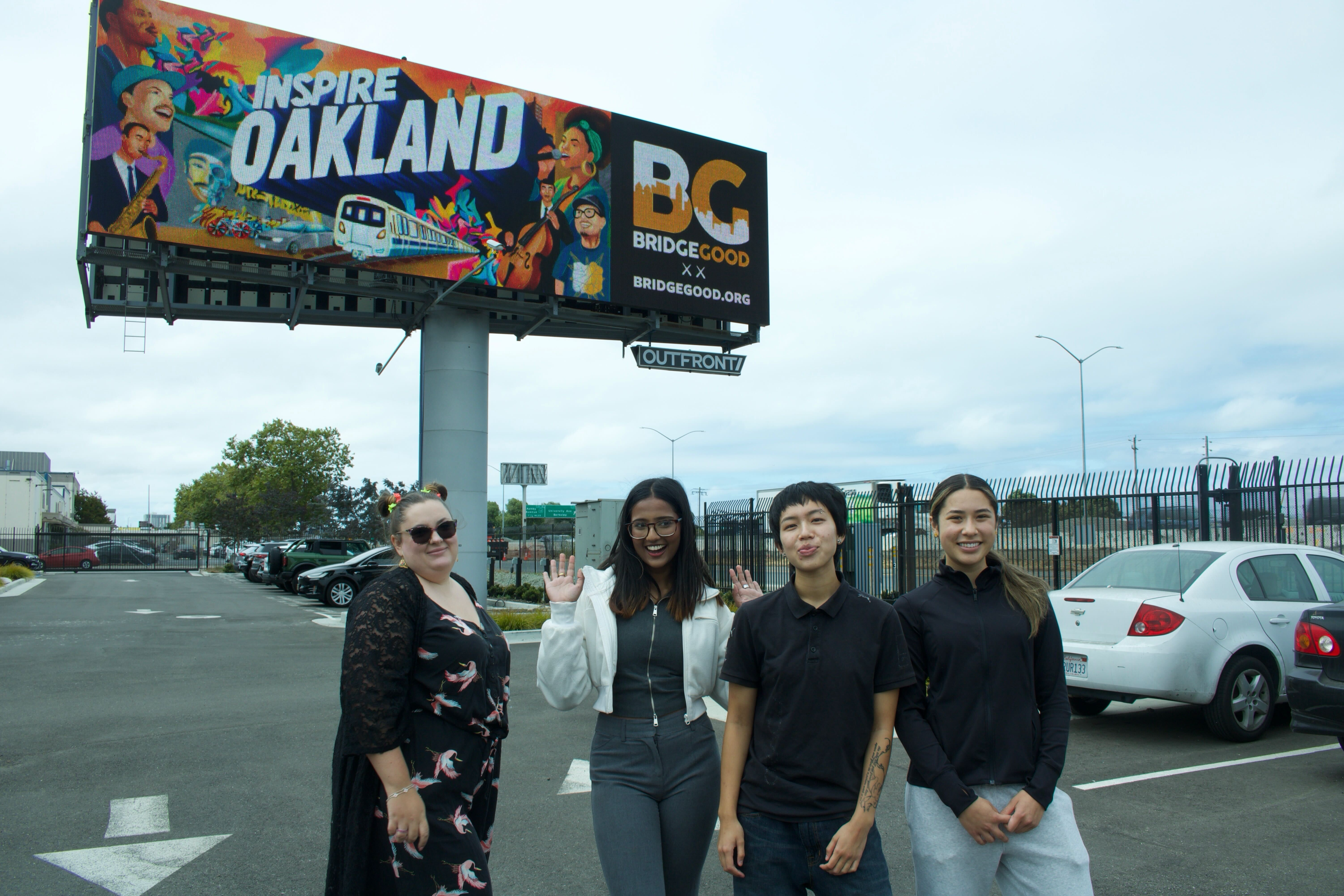 Team photo in front of the live billboard