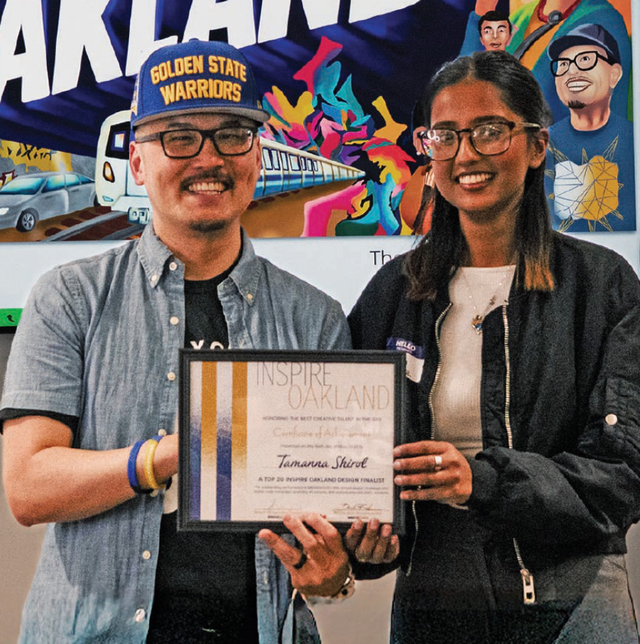 Shaund and tamanna taking a photo with the certificate