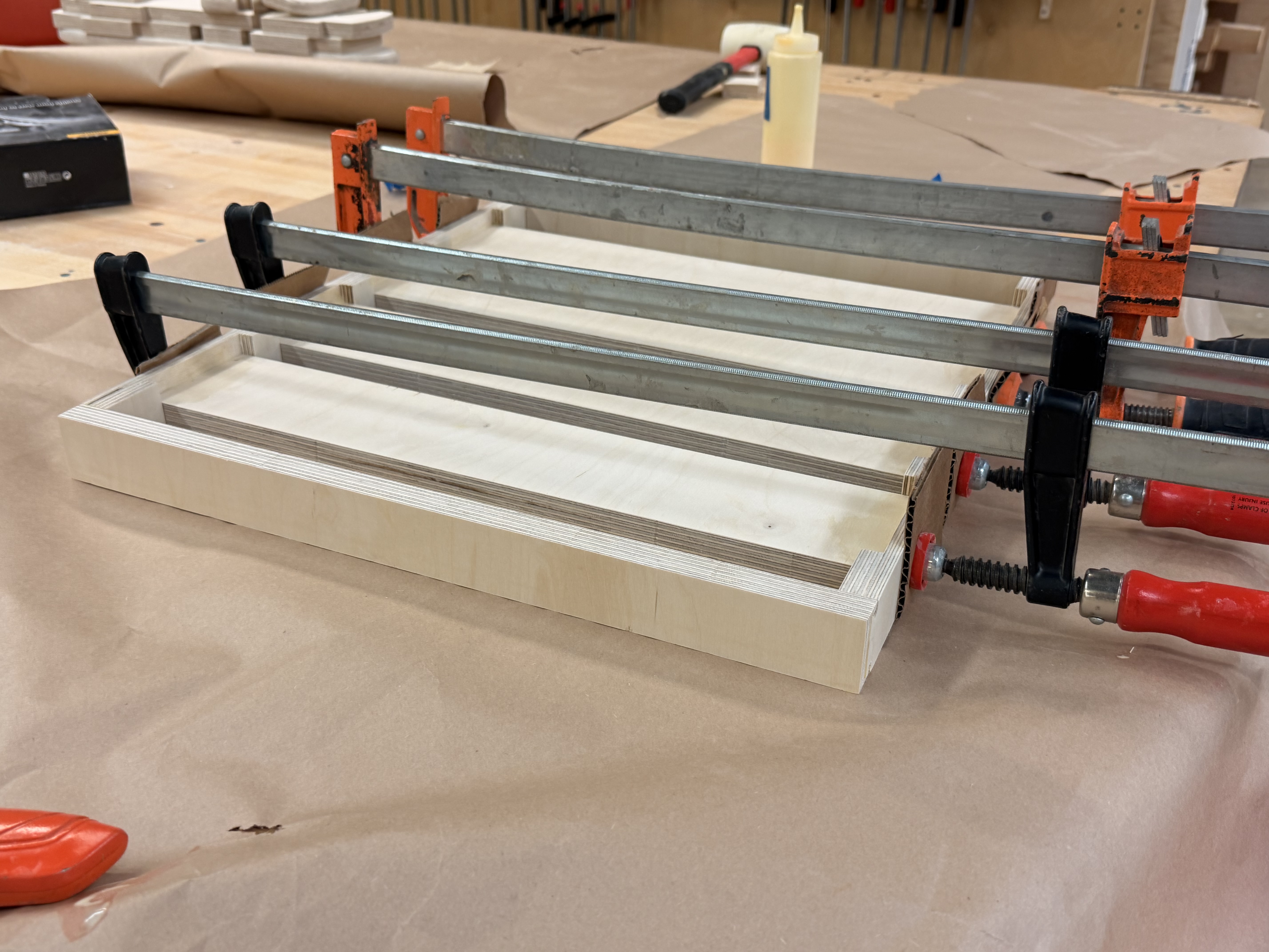 Seat slats being glued and clamped flat